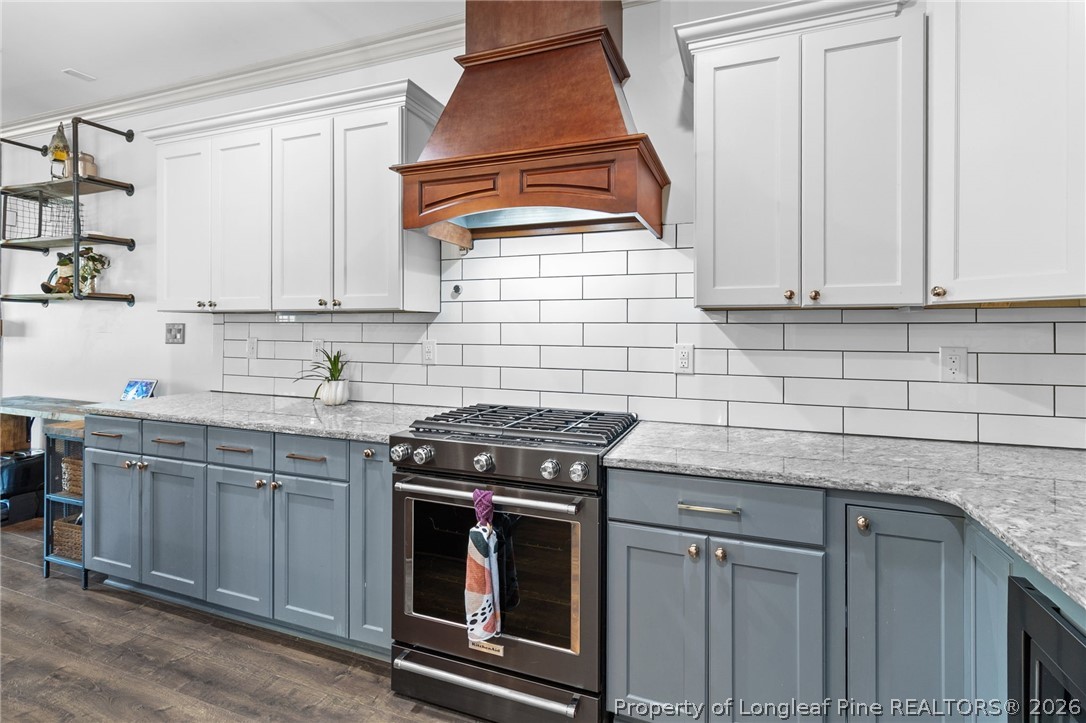 5535 Butler Nursery Road Fayetteville, NC 28306 - Photo 13 of 50 a kitchen with granite countertop a sink a stove and cabinets