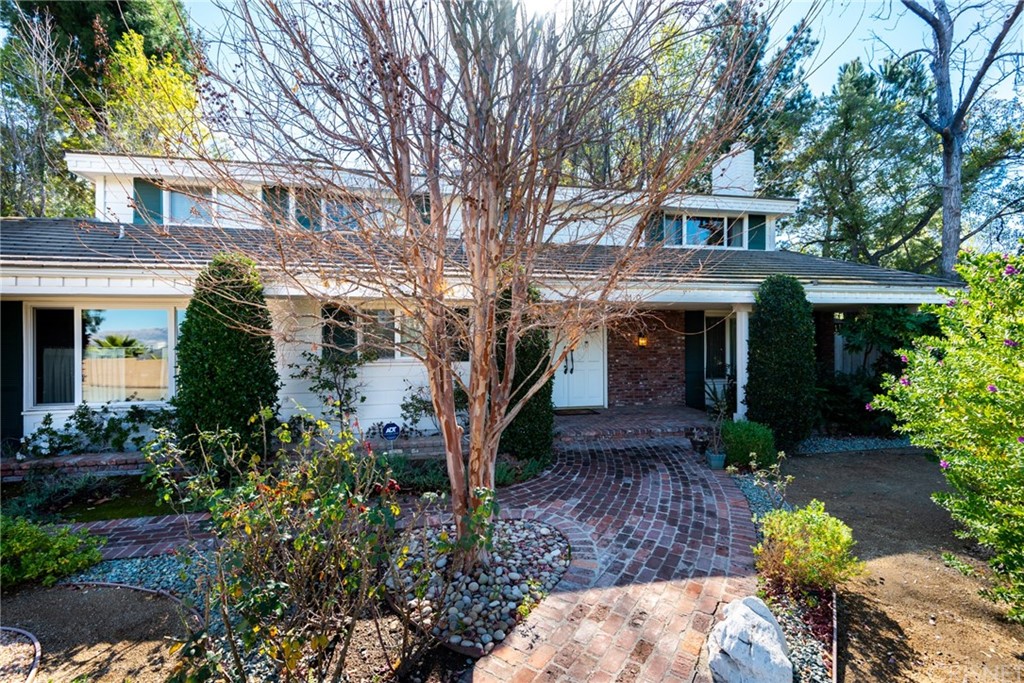 a front view of a house with a yard and outdoor seating