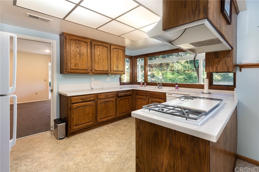 20140 Adele Drive Woodland Hills, CA 91364 - Photo 13 of 20 a kitchen that has a sink cabinets counter space and a window