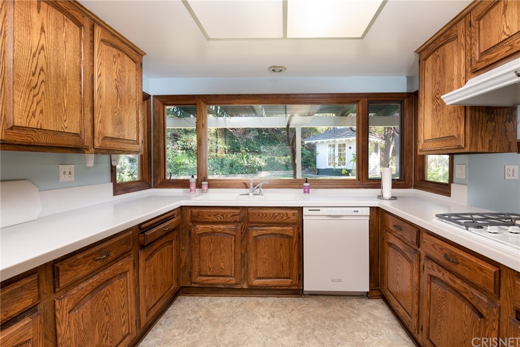 20140 Adele Drive Woodland Hills, CA 91364 - Photo 15 of 20 a kitchen with a sink stove and cabinets