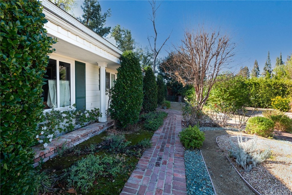 20140 Adele Drive Woodland Hills, CA 91364 - Photo 2 of 20 a view of a pathway with a garden