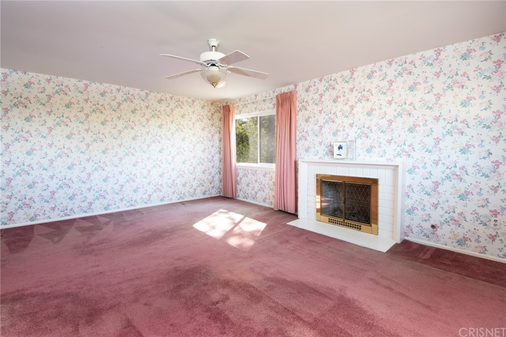 20140 Adele Drive Woodland Hills, CA 91364 - Photo 7 of 20 an empty room with windows and fireplace