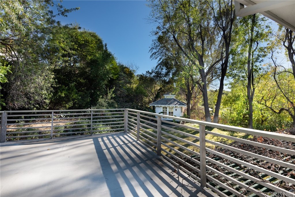 20140 Adele Drive Woodland Hills, CA 91364 - Photo 10 of 20 a view of a balcony with wooden floor and fence and a bench