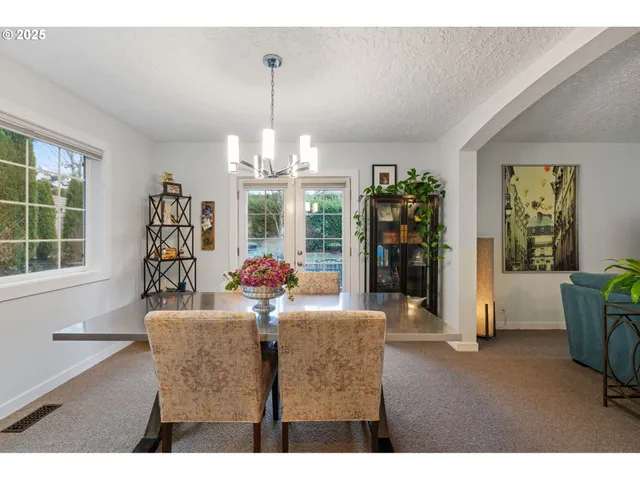 a living room with furniture and chandelier