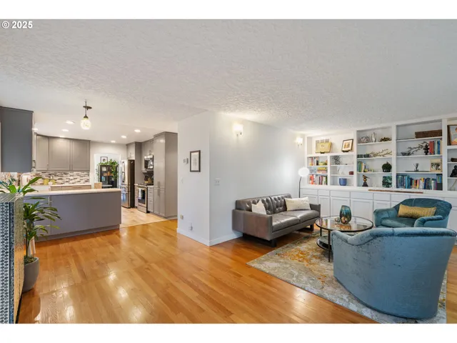 a living room with furniture and a book shelf