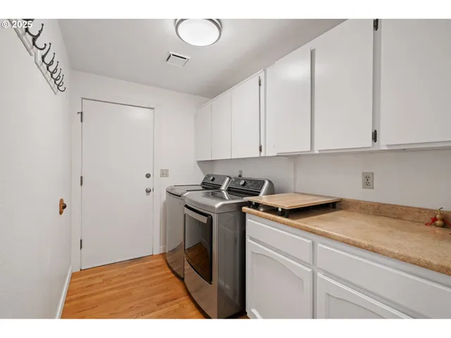 a view of a kitchen with sink and cabinets