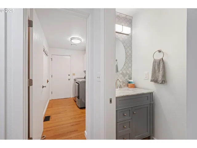 a bathroom with a sink vanity mirror and toilet