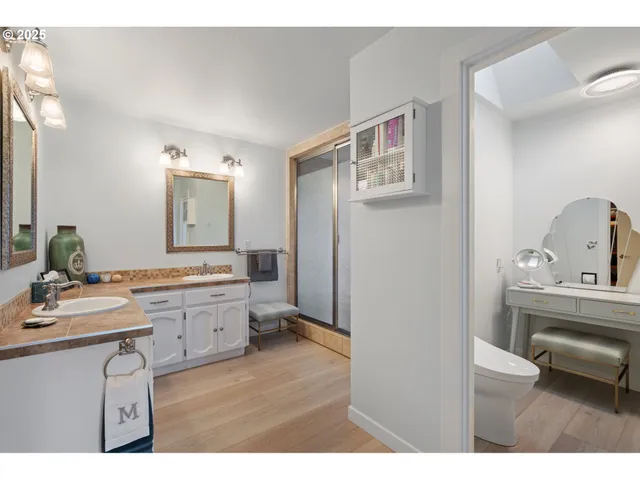 a bathroom with a sink vanity granite and a mirror