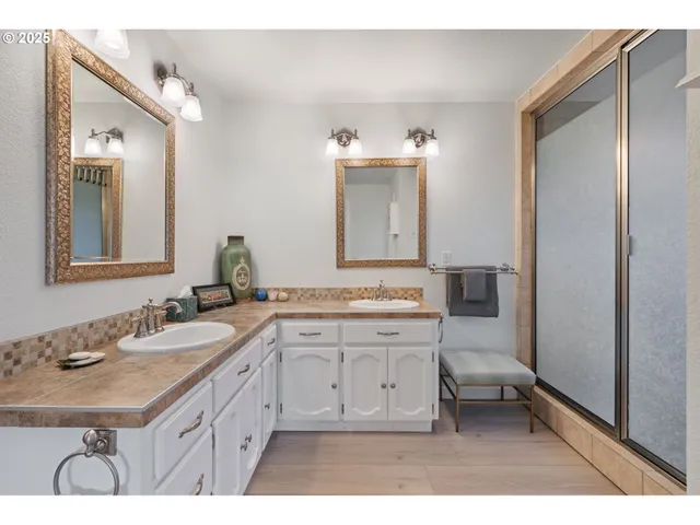 a spacious bathroom with a granite countertop sink a mirror and a