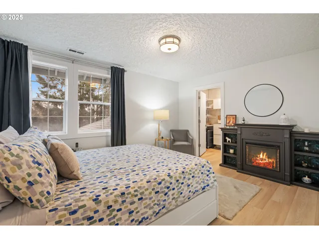 a bedroom with a bed and a fireplace