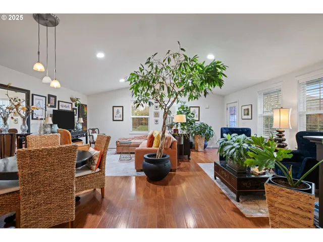 a living room with furniture potted plant and a window