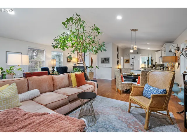a living room with furniture kitchen and a chandelier