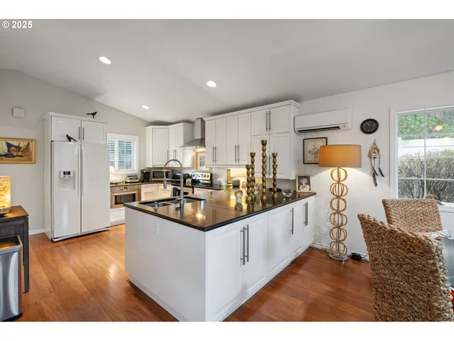 a kitchen with stainless steel appliances kitchen island granite countertop a sink and cabinets