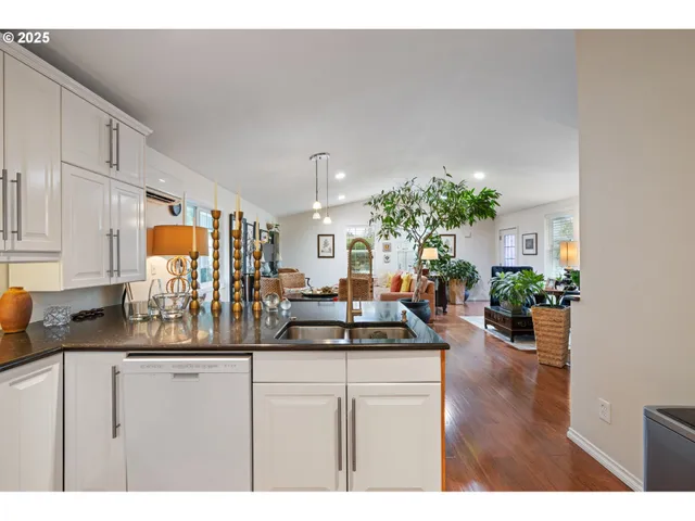 a kitchen with sink and view of living room