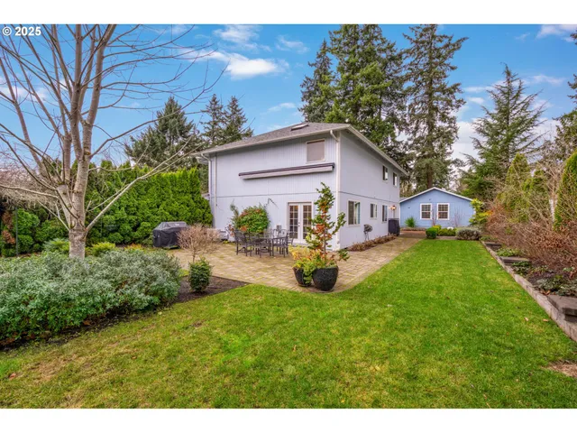 a front view of a house with patio and garden