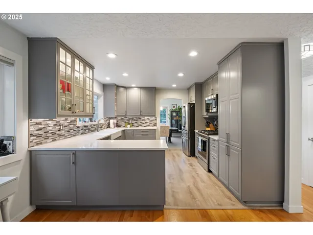 a kitchen with kitchen island sink and refrigerator
