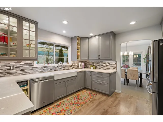 a large kitchen with a sink and cabinets