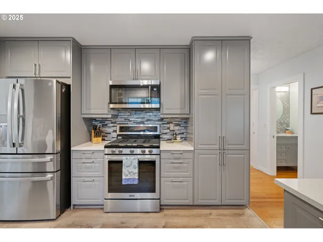 a kitchen with a refrigerator stove and microwave