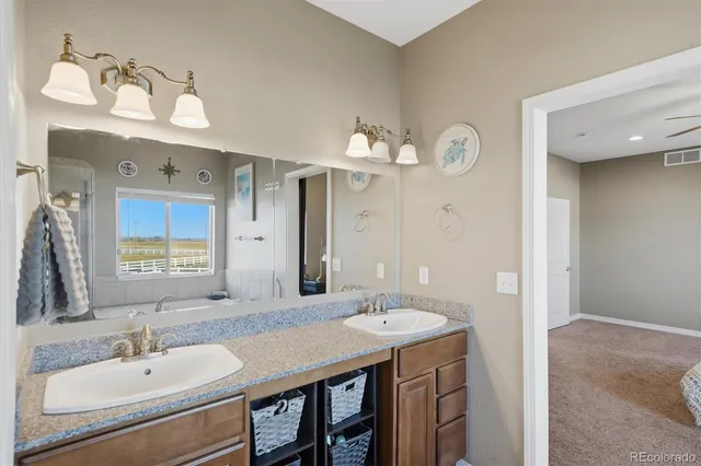 a bathroom with a granite countertop sink mirror toilet and shower