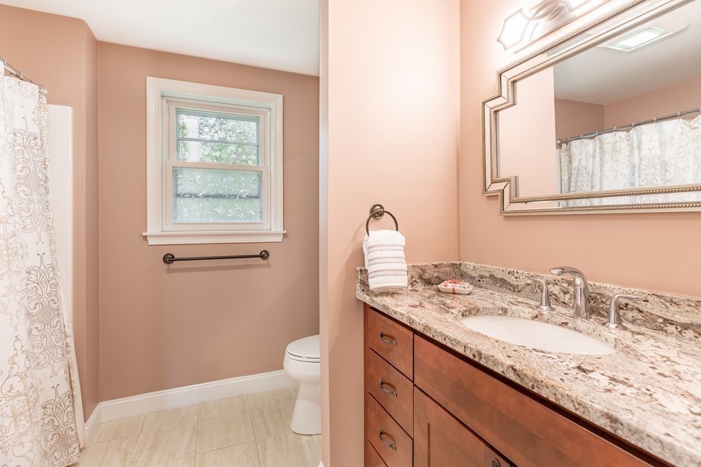 24 Oxbow Road Lexington, MA 02421 - Photo 15 of 28 a bathroom with a granite countertop sink toilet and mirror