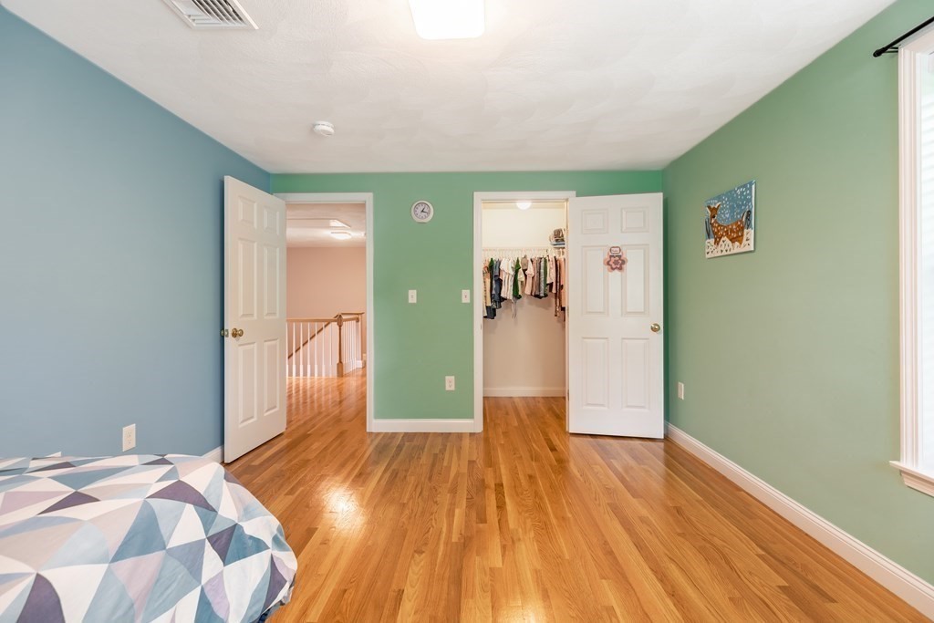 24 Oxbow Road Lexington, MA 02421 - Photo 19 of 28 a bedroom with a bed and wooden floor