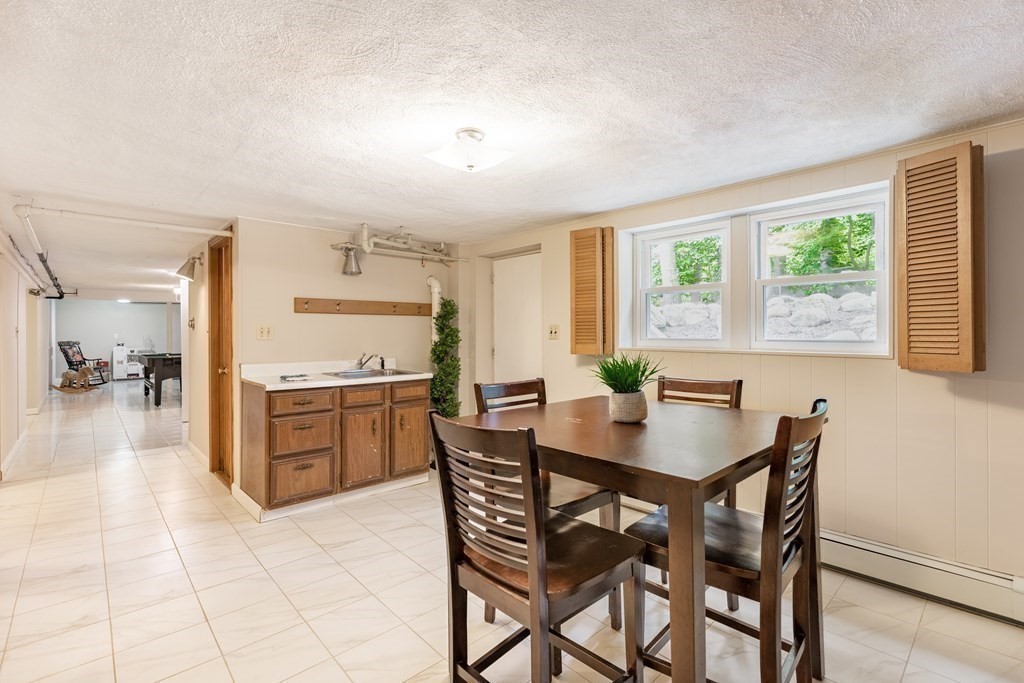 24 Oxbow Road Lexington, MA 02421 - Photo 21 of 28 a dining room with a wooden table and chairs