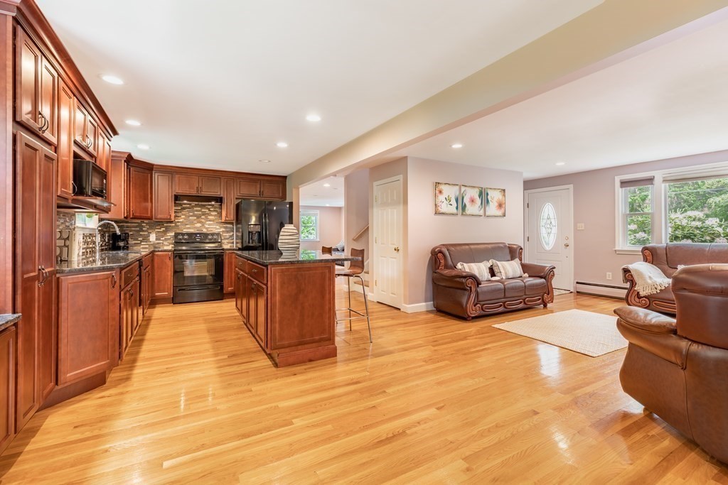 24 Oxbow Road Lexington, MA 02421 - Photo 5 of 28 a living room with stainless steel appliances furniture windows and a kitchen view