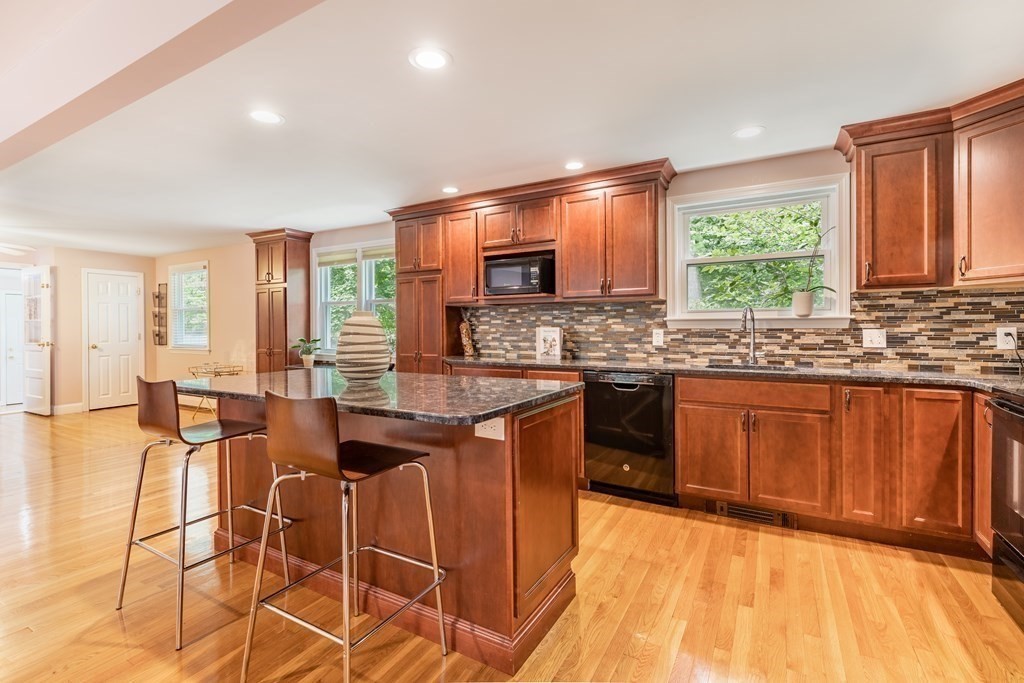 24 Oxbow Road Lexington, MA 02421 - Photo 6 of 28 a kitchen with stainless steel appliances granite countertop wooden cabinets a sink and dishwasher a stove with wooden floor