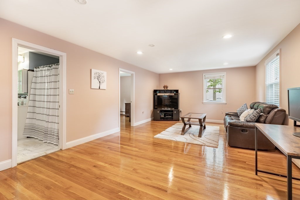 24 Oxbow Road Lexington, MA 02421 - Photo 8 of 28 a living room with furniture and a flat screen tv
