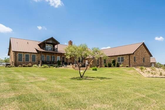 7701 Canyon Bend Road Amarillo, TX 79118 - Photo 1 of 72 a front view of a house with a yard