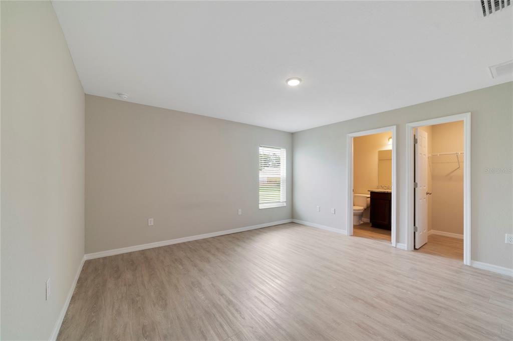 16271 Southwest 27th Terrace Road Ocala, FL 34473 - Photo 15 of 21 an empty room with wooden floor and windows