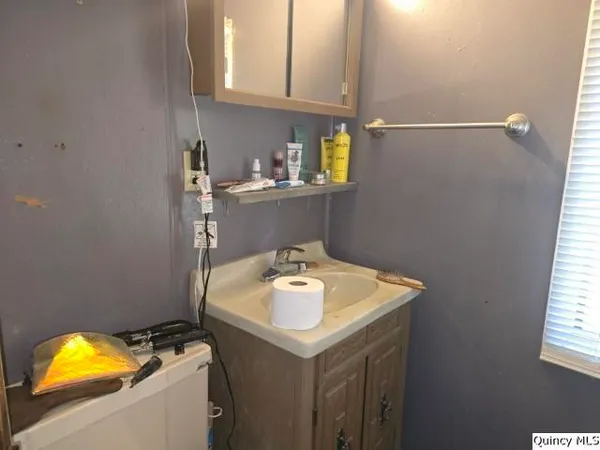 a bathroom with a sink and cabinets
