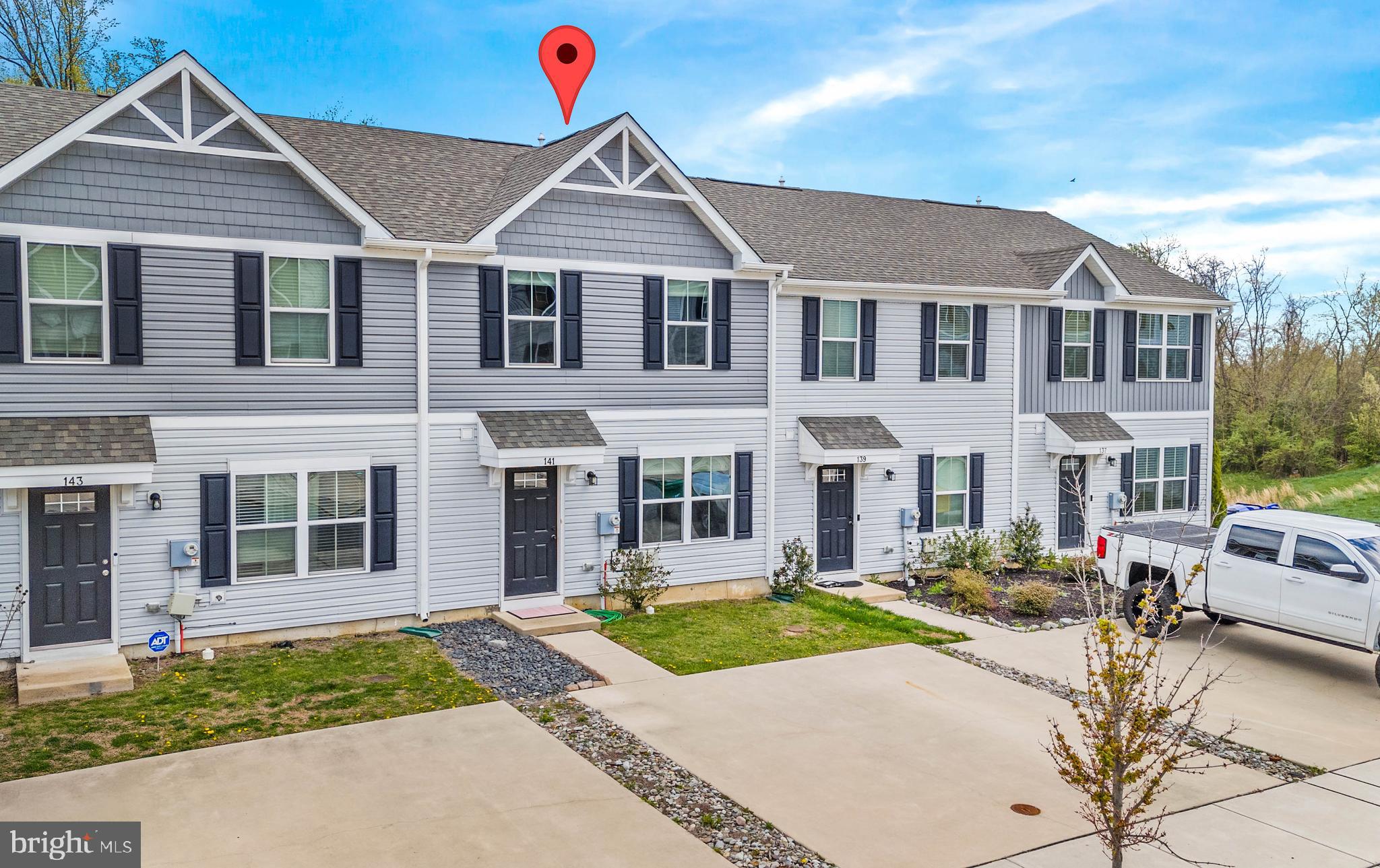 141 Wye Oak Drive Townsend, DE 19734 - Photo 3 of 32 a view of a white house with a large windows next to a yard