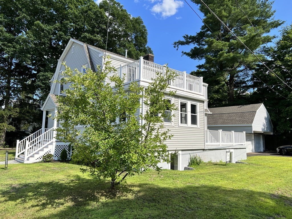 48 Pinewood Avenue Billerica, MA 01821 - Photo 1 of 26 a view of a house with a yard and plants