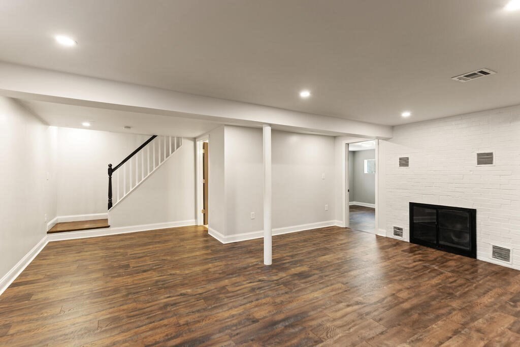 48 Pinewood Avenue Billerica, MA 01821 - Photo 13 of 26 a view of an empty room with wooden floor fireplace and a window