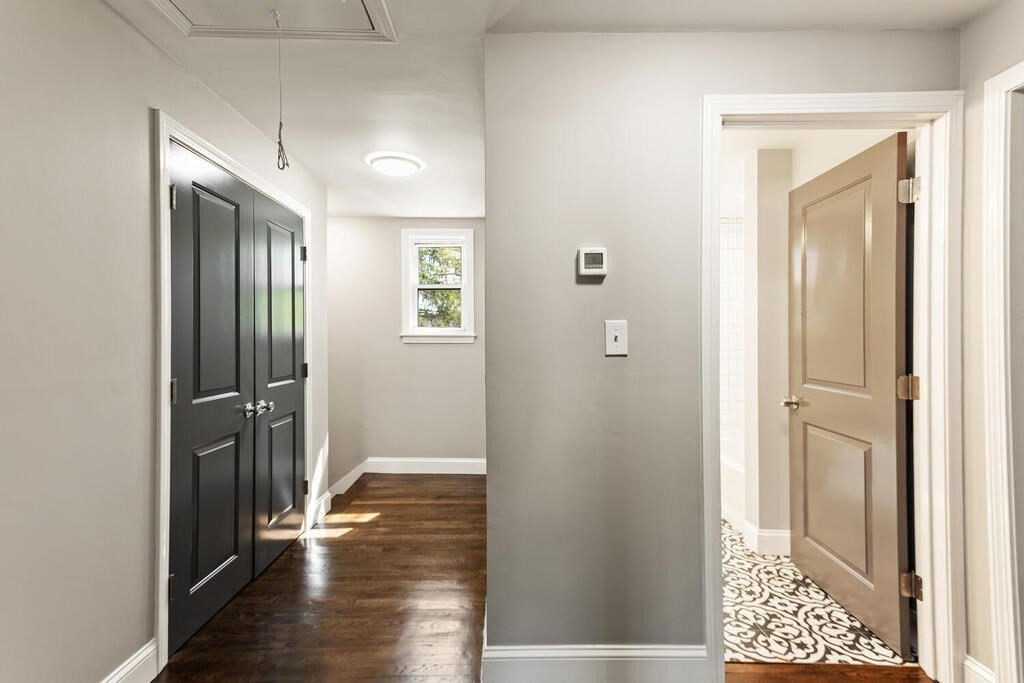 48 Pinewood Avenue Billerica, MA 01821 - Photo 17 of 26 a view of a hallway with wooden floor and a bathroom