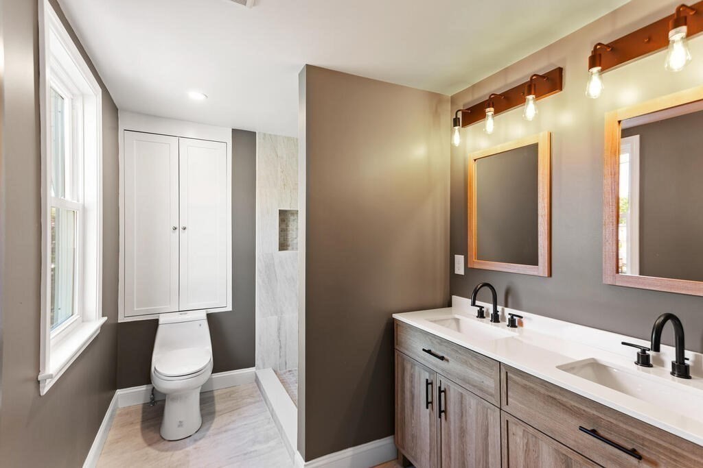 48 Pinewood Avenue Billerica, MA 01821 - Photo 22 of 26 a bathroom with a toilet sink a mirror and shower