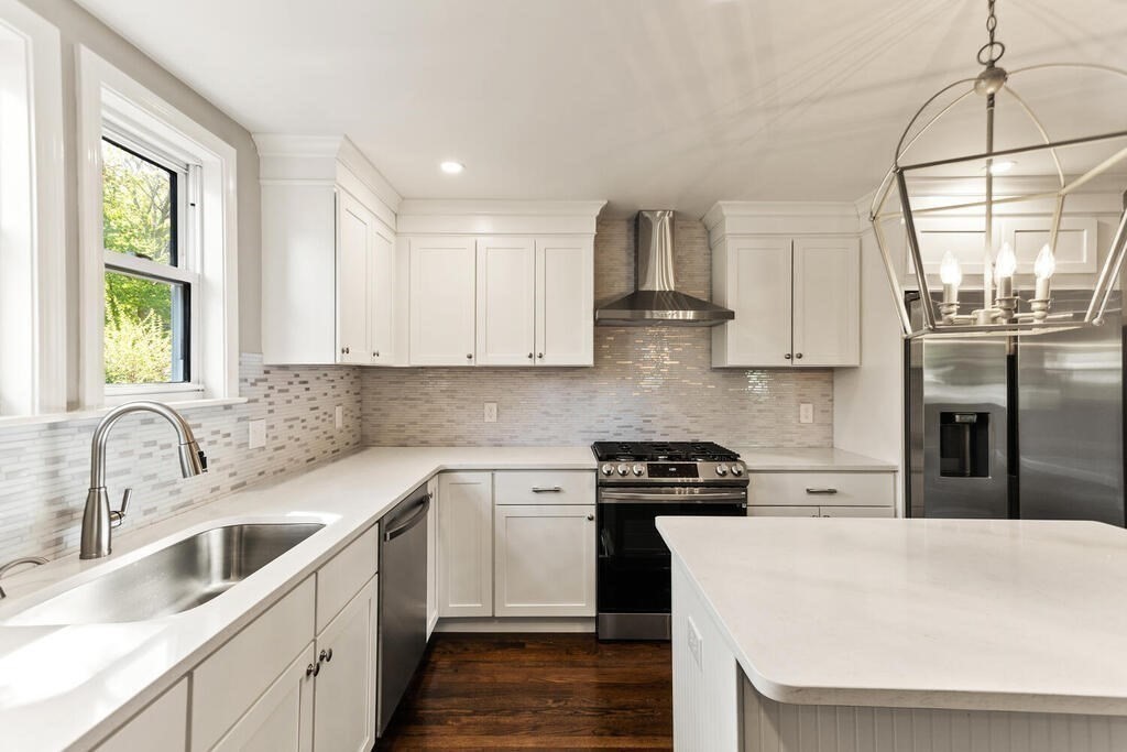 48 Pinewood Avenue Billerica, MA 01821 - Photo 3 of 26 a kitchen with a white cabinets and window