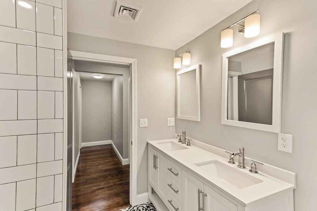 48 Pinewood Avenue Billerica, MA 01821 - Photo 4 of 26 a bathroom with a double vanity sink and a mirror