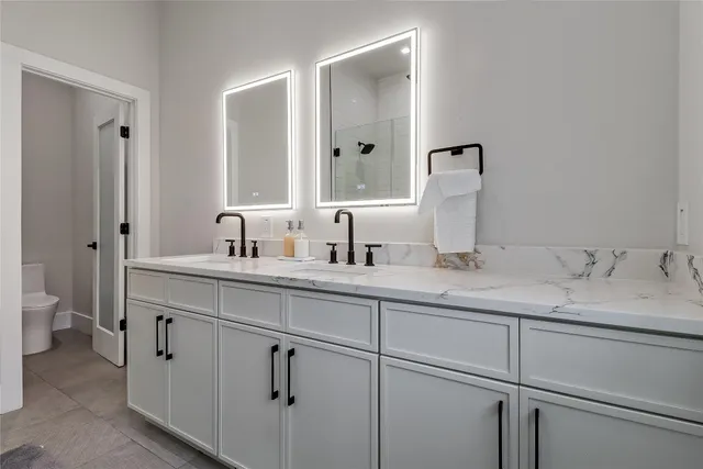 a bathroom with a double vanity sink and mirror