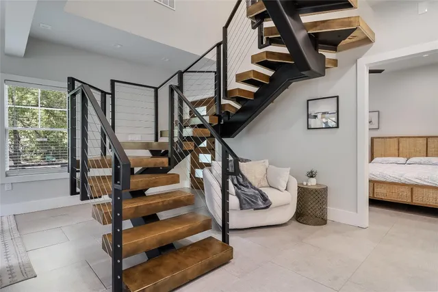 a view of hall way with furniture and staircase