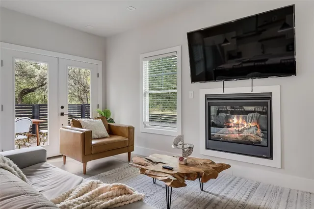 a living room with furniture a flat screen tv and a fireplace