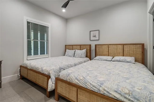 a bed sitting in a bedroom next to a window