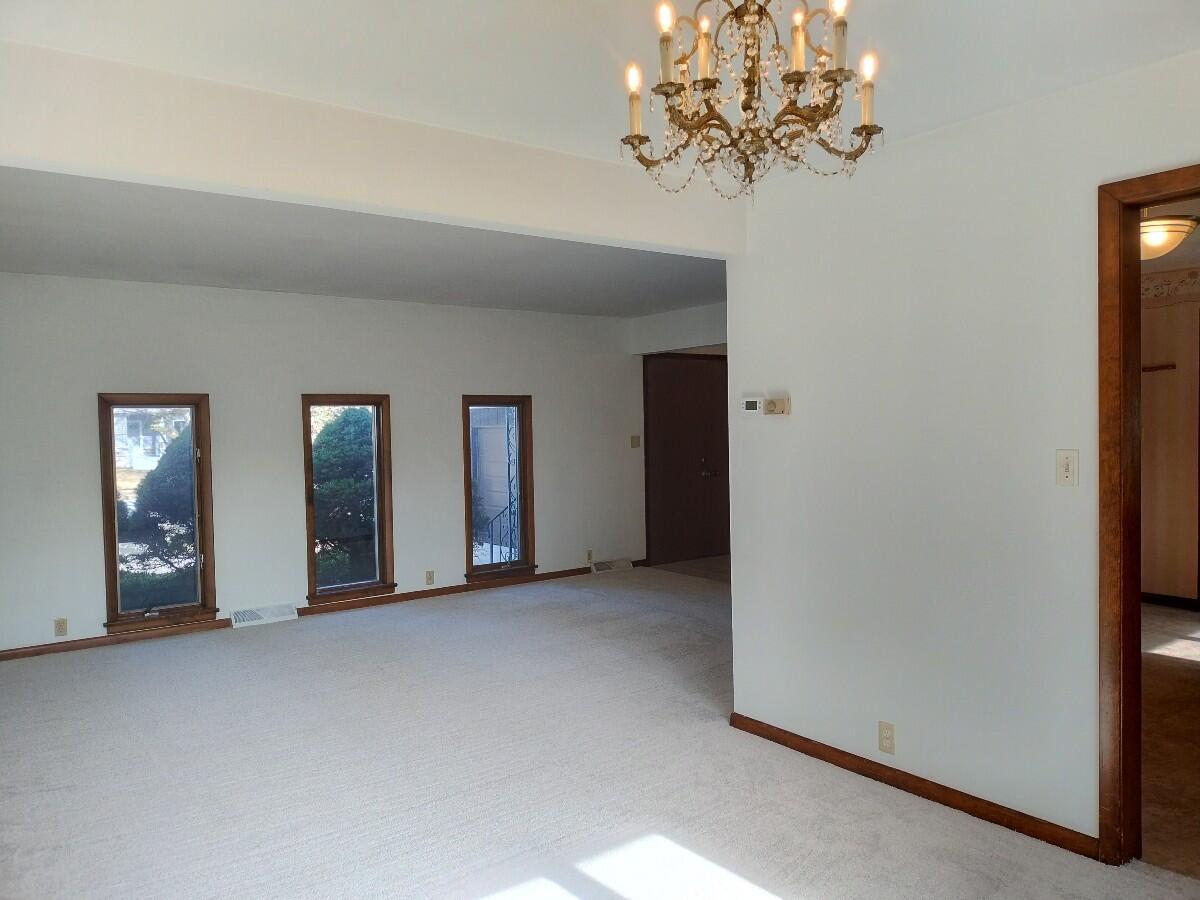 1040 Azalea Drive Munster, IN 46321 - Photo 3 of 16 a view of a hallway with a chandelier