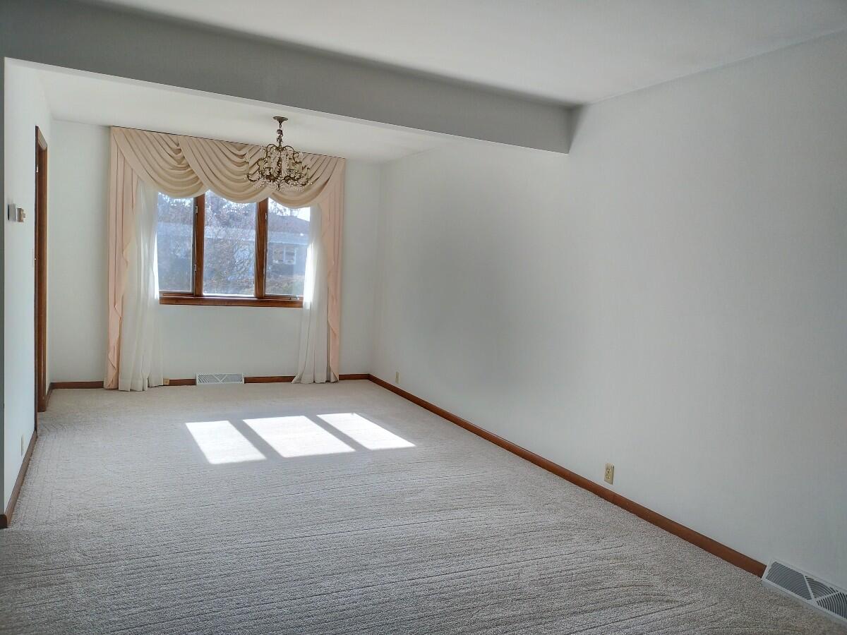1040 Azalea Drive Munster, IN 46321 - Photo 4 of 16 wooden floor in an empty room with a window
