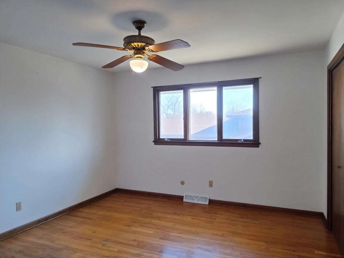 1040 Azalea Drive Munster, IN 46321 - Photo 8 of 16 a view of an empty room with wooden floor and a window