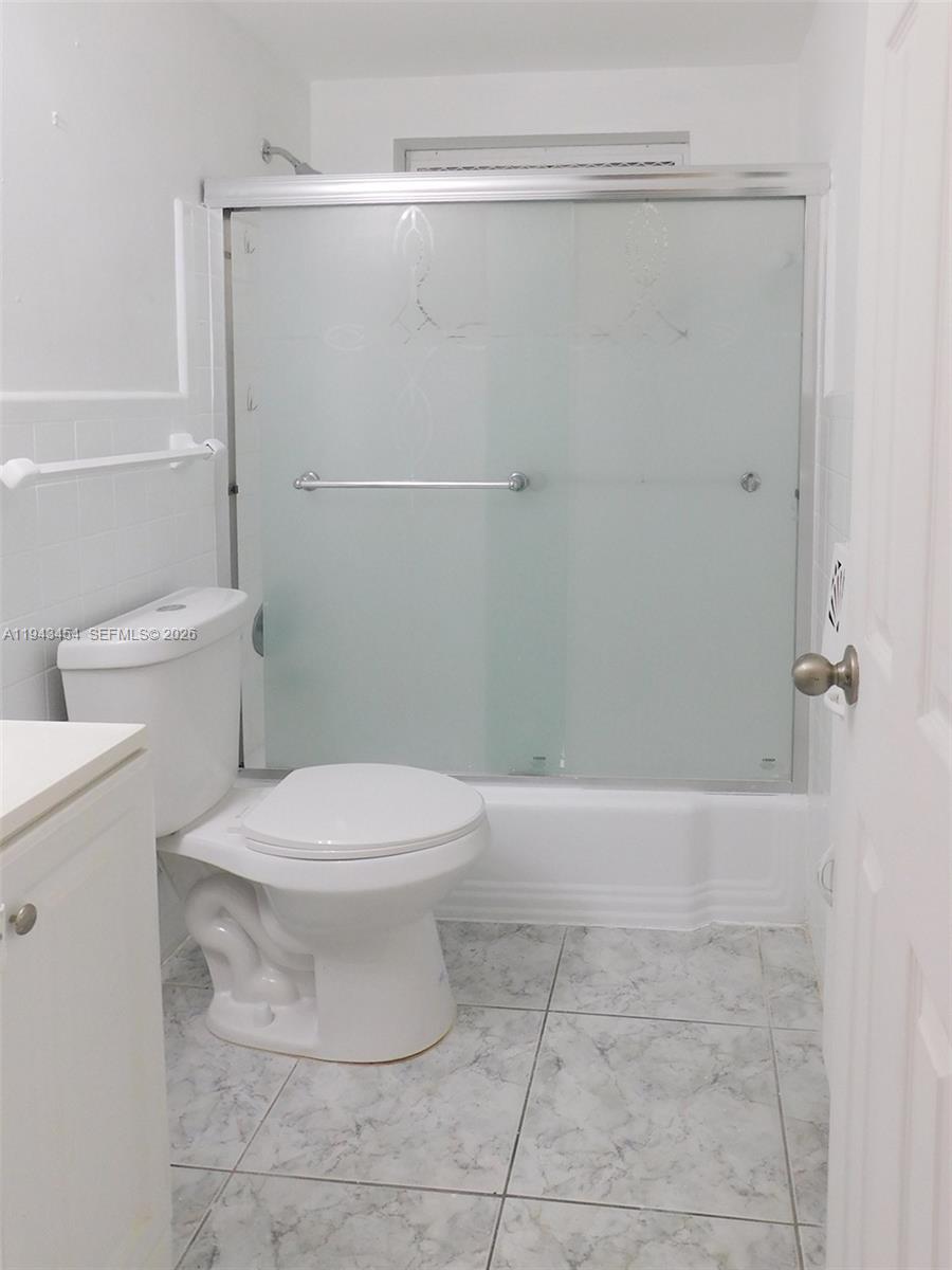 7840 Harding Avenue, Unit 2 Miami Beach, FL 33141 - Photo 15 of 19 a bathroom with a toilet and a shower