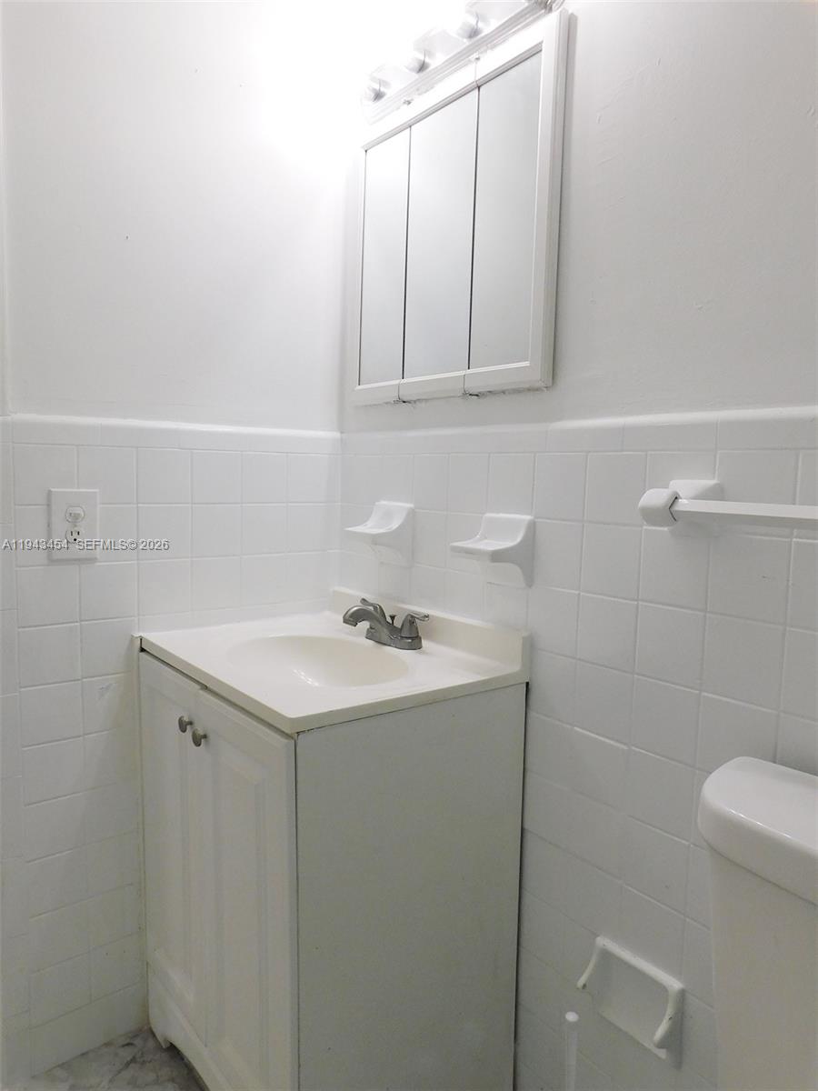 7840 Harding Avenue, Unit 2 Miami Beach, FL 33141 - Photo 16 of 19 a bathroom with a sink and a toilet