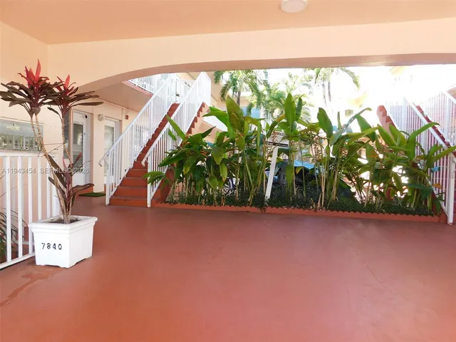a view of an entryway with a tree in the background