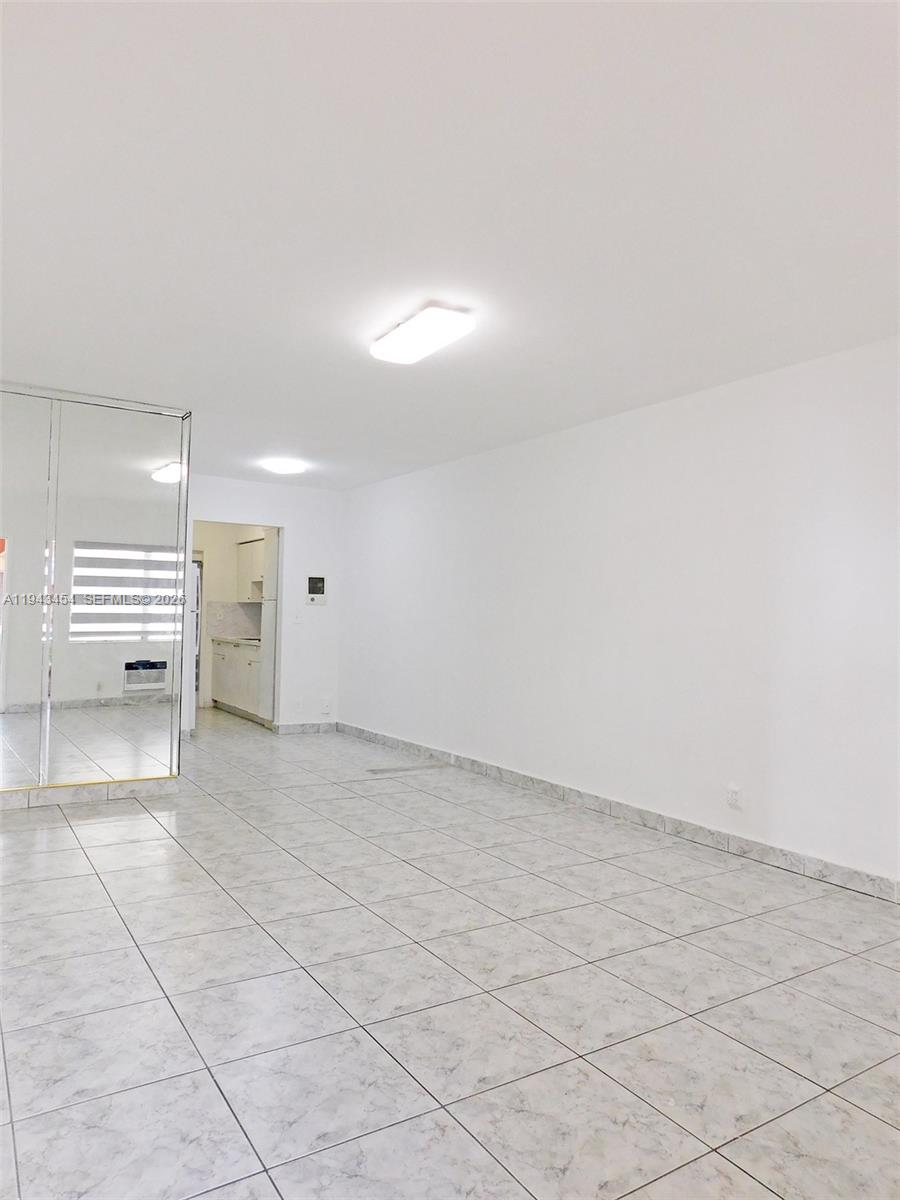 7840 Harding Avenue, Unit 2 Miami Beach, FL 33141 - Photo 4 of 19 an empty room with a bench